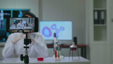 asian scientist man shooting video with a smartphone