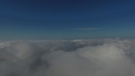 flying over the high mountains in beautiful clouds. aerial view.