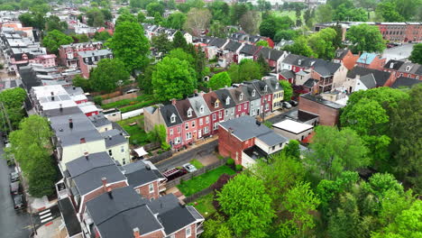 aerial reverse rising shot of tightly packed homes in city