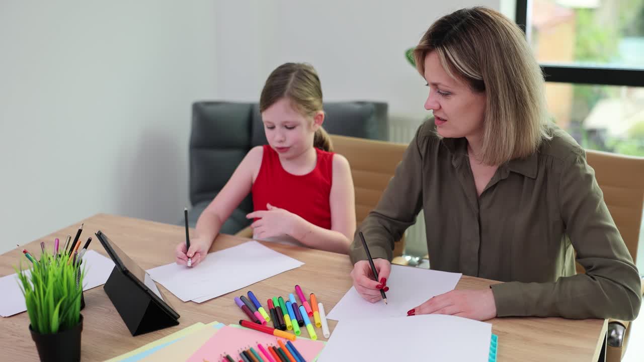 Mother and Daughter drawing indoors