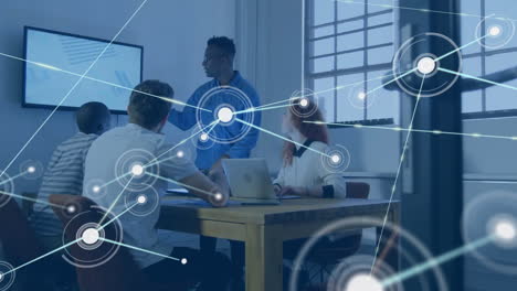animation of network of connections with icons over diverse colleagues discussing work