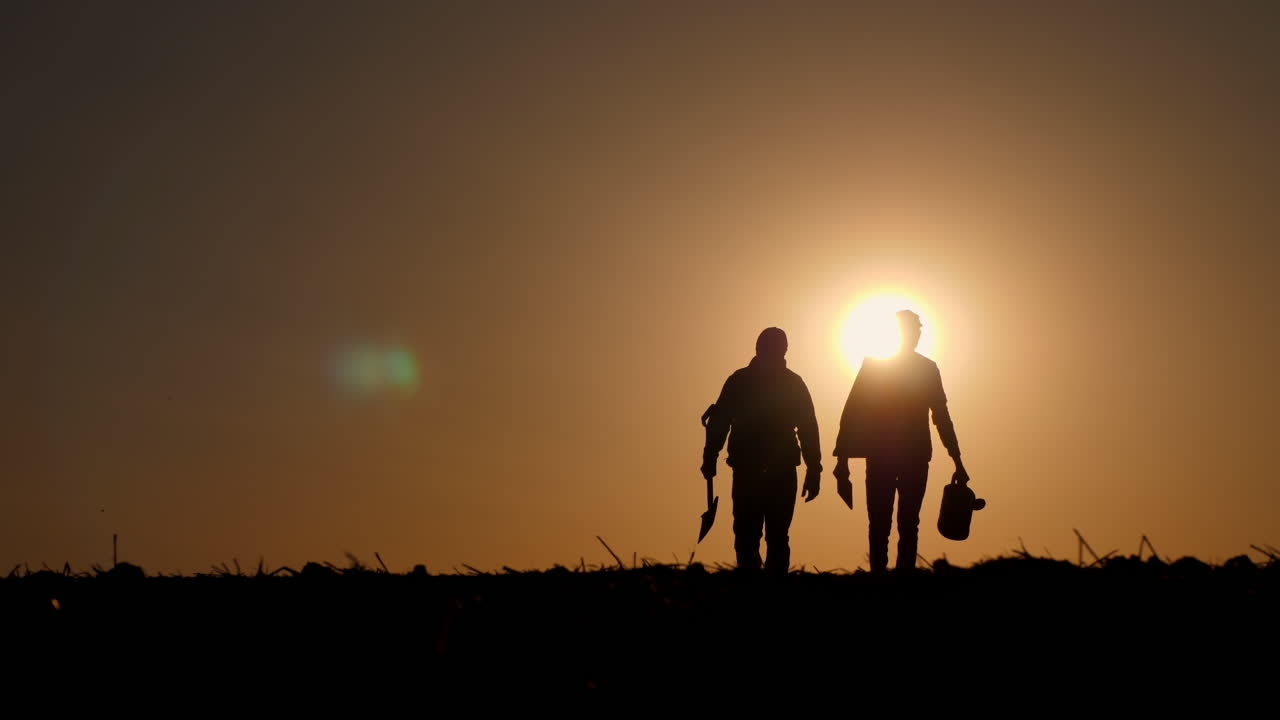 Silhouettes of People Working at Sunset