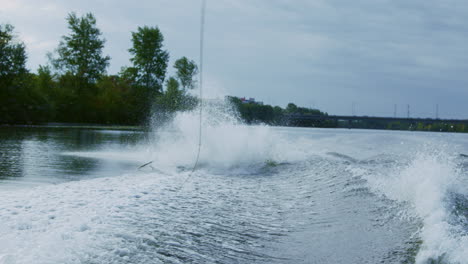 rider falling from wakeboard into river. sportsman failing. fall on water