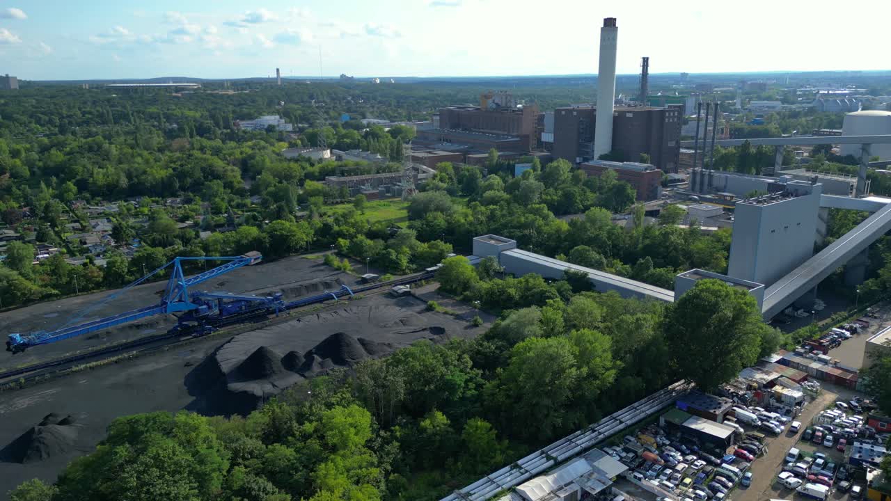 hard coal fired power station transporting coal on conveyor belts, showcasing industrial infrastructure in a city. Magic aerial view flight panorama orbit drone