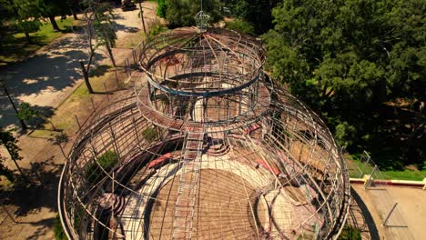 aerial orbit over the abandoned art nouveau greenhouse of the quinta normal in santiago chile on a sunny day, without glasses