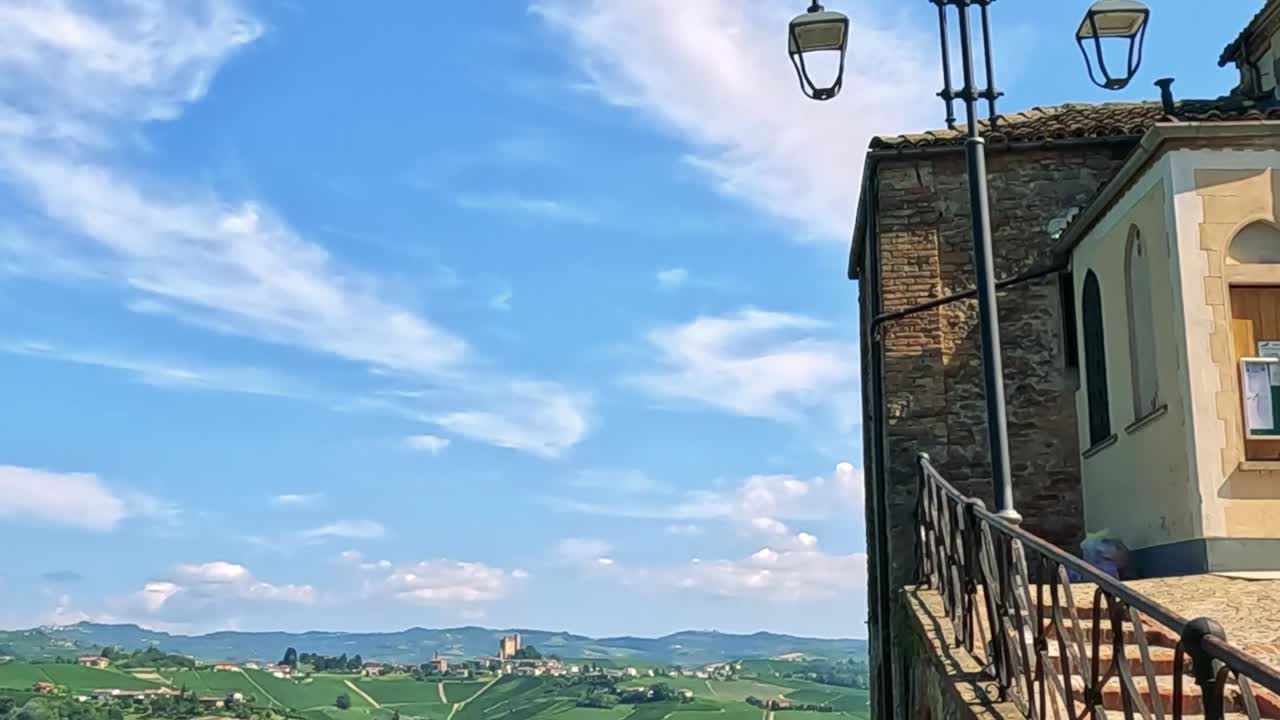 A detailed view of a historic church facade under a vibrant blue sky with wispy clouds.