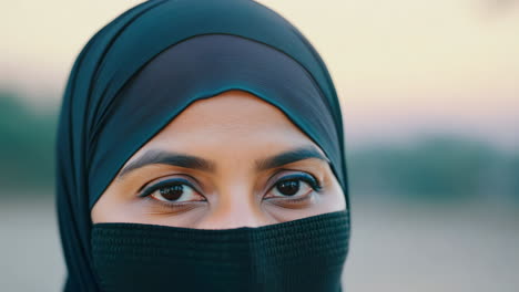 close-up portrait of woman wearing hijab in natural light during day