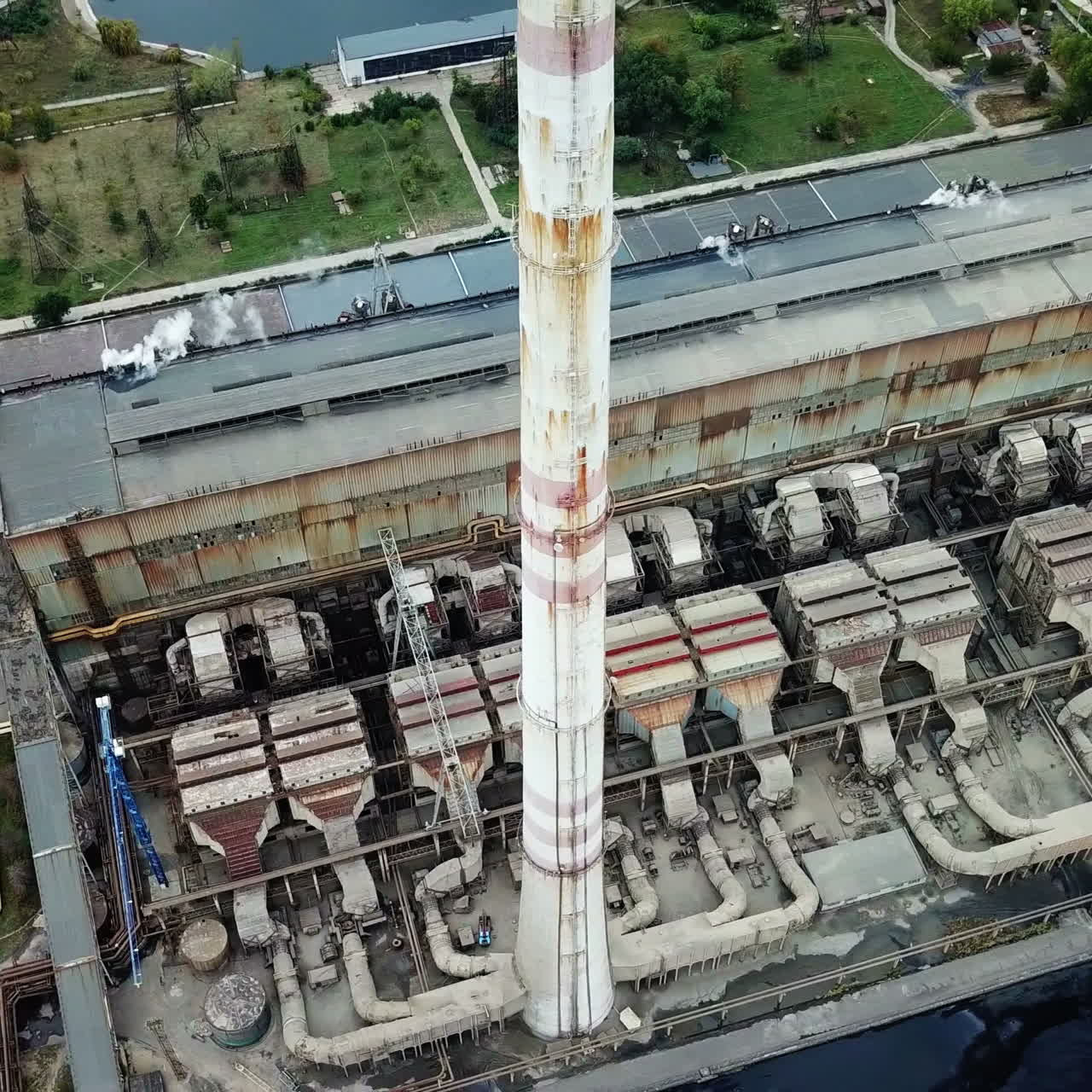 Aerial view. Thermal power station on the river bank. Industrial zone from above.
