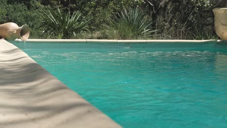 cozy outdoor swimming pool with turquoise water and greenery around