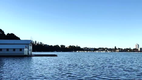 boathouse centred horizon on swan river at peppermint grove, perth, western australia