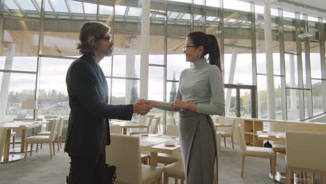 business people shaking hands in a modern restaurant or hotel dining area