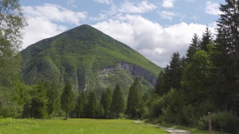 a lone hiker going down a path with a dramatic mountain in the background