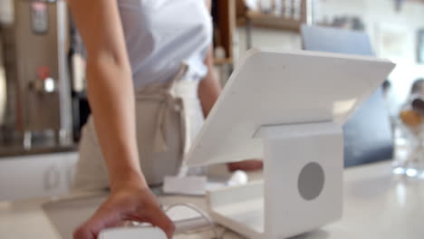 Customer-at-coffee-shop-paying-waitress-with-credit-card