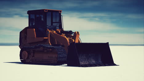 road grading machine on the salt desert road