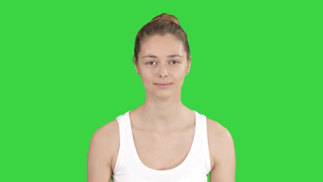 young woman doing breathing exercise on a green screen, chroma key