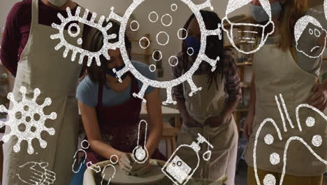 animación de iconos de covid-19 sobre mujeres que trabajan en un estudio de cerámica con máscaras faciales