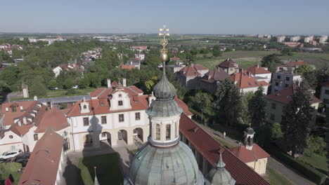 Drone-Shot,-Top-of-Dome-and-Cross-on-Church-of-Our-Lady-Victorious,-Bílá-Hora,-Prague,-Czech-Republic