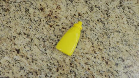 Bottle-of-mustard-on-marble-background