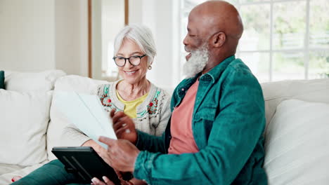 old couple on sofa with documents