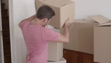 handsome man putting two boxes on another one