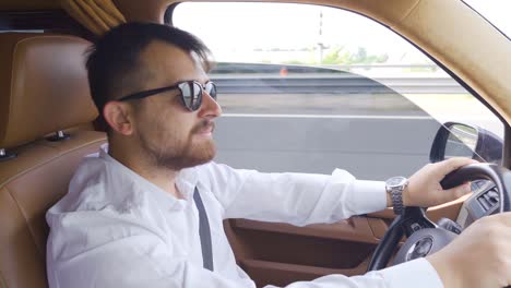 happy businessman driving a car.