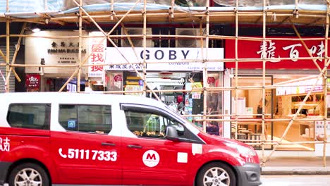 scaffolding setup with passing vehicles in hong kong