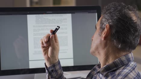 man working on written document.