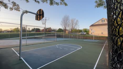 suburban empty basketball court sunset