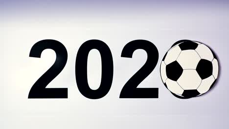 ilustración, año nuevo, mano masculina puesta sobre la mesa en una pelota de fútbol, 2020