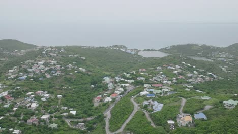 Aerial-shot-capturing-Grand-Case-town-surrounded-with-greenery-in-Saint-Martin,-Carribean-Island