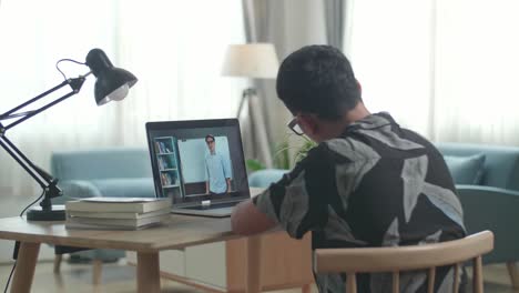 asia teen boy student distance learning with online teacher on computer screen from home
