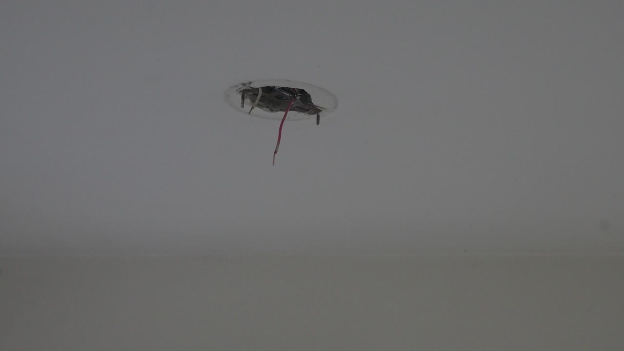 Connecting wires hanging down from the ceiling after fixture removal