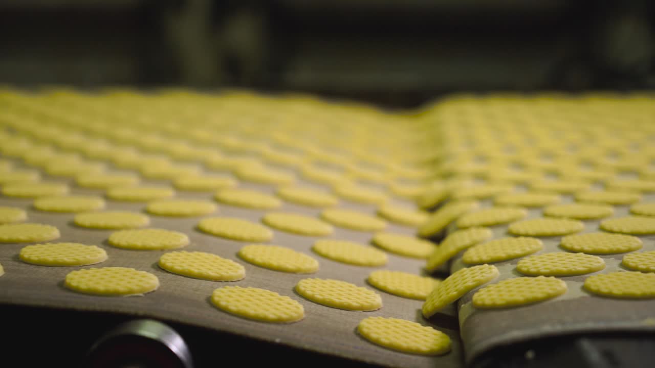 Racking foucs shot of biscuits in a production line of a factory