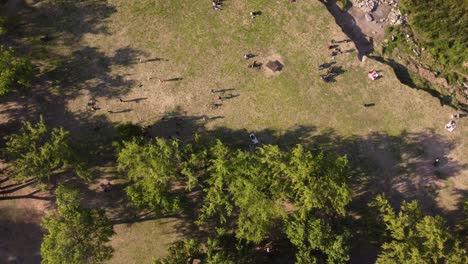 Aerial-drone-shot-showing-group-of-Jugglers-practicing-soccer-skills-in-park-during-sunlight---Vincente-Lopez,Buenos-Aires---4K-30fps