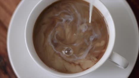 pouring milk in a cup of coffee stock video stock footage