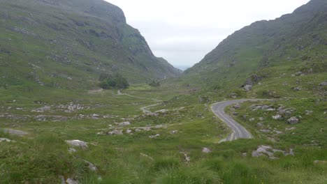 road traversing narrow mountain pass in killarney national park