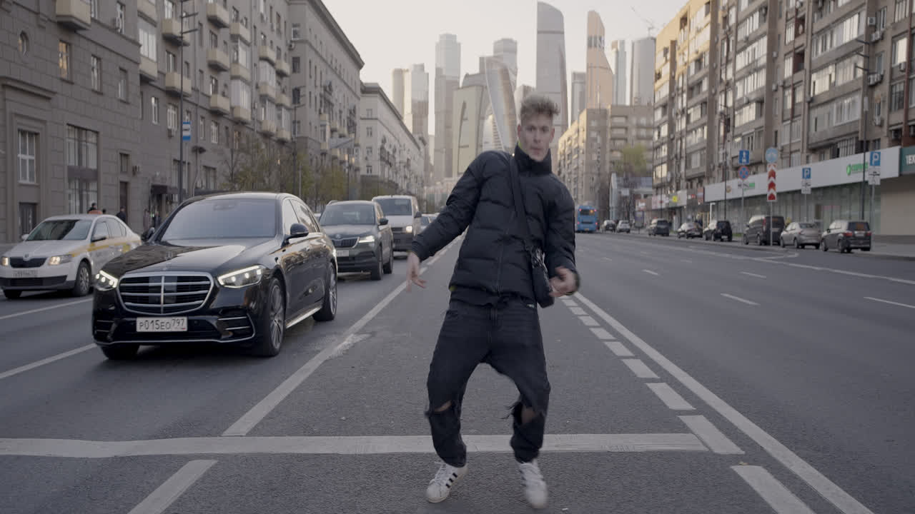 Young Man Dancing on City Street