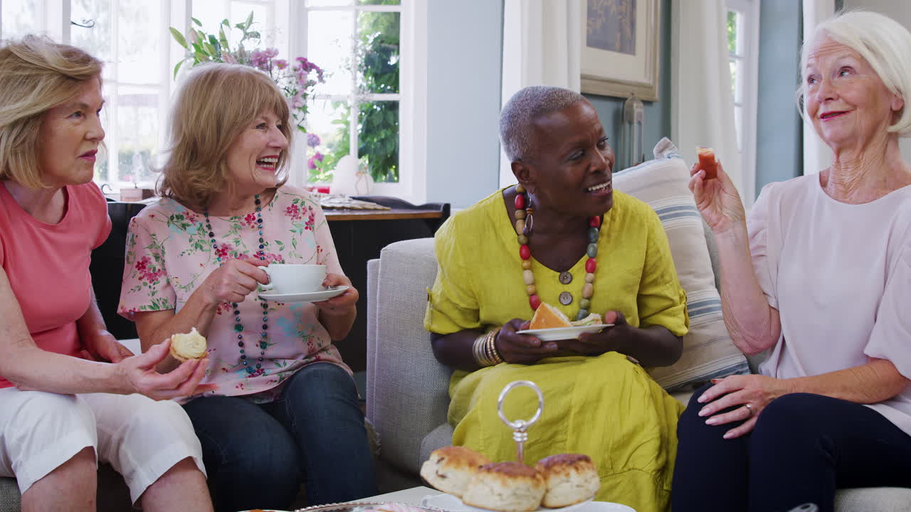 Senior Female Friends Enjoying Afternoon Tea At Home Together