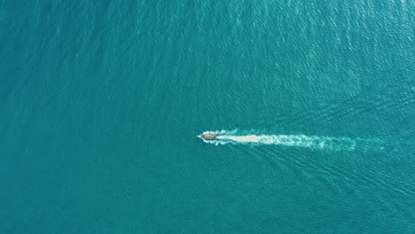 Aerial-view-of-Long-Tail-Boats-floating-on-crystal-water-along-the-sand-beach-in-Thailand