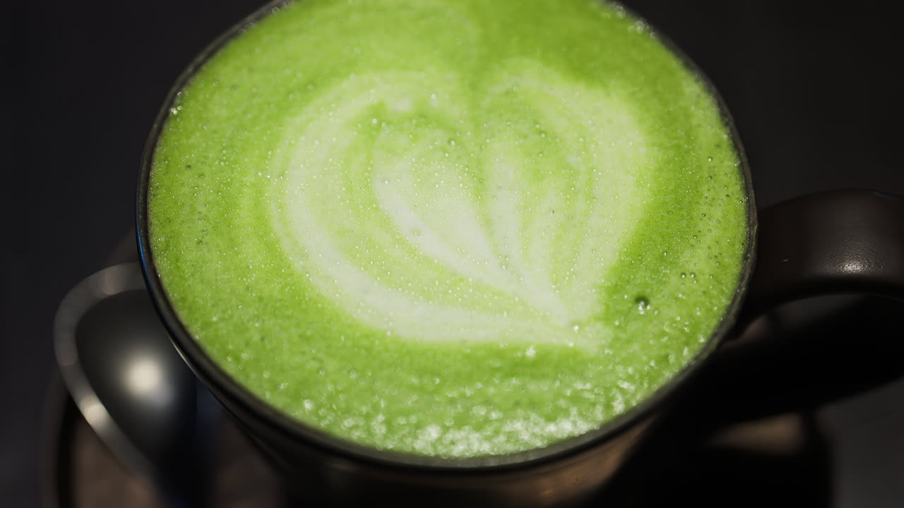 Close up of a matcha latte on a tray at a cafe