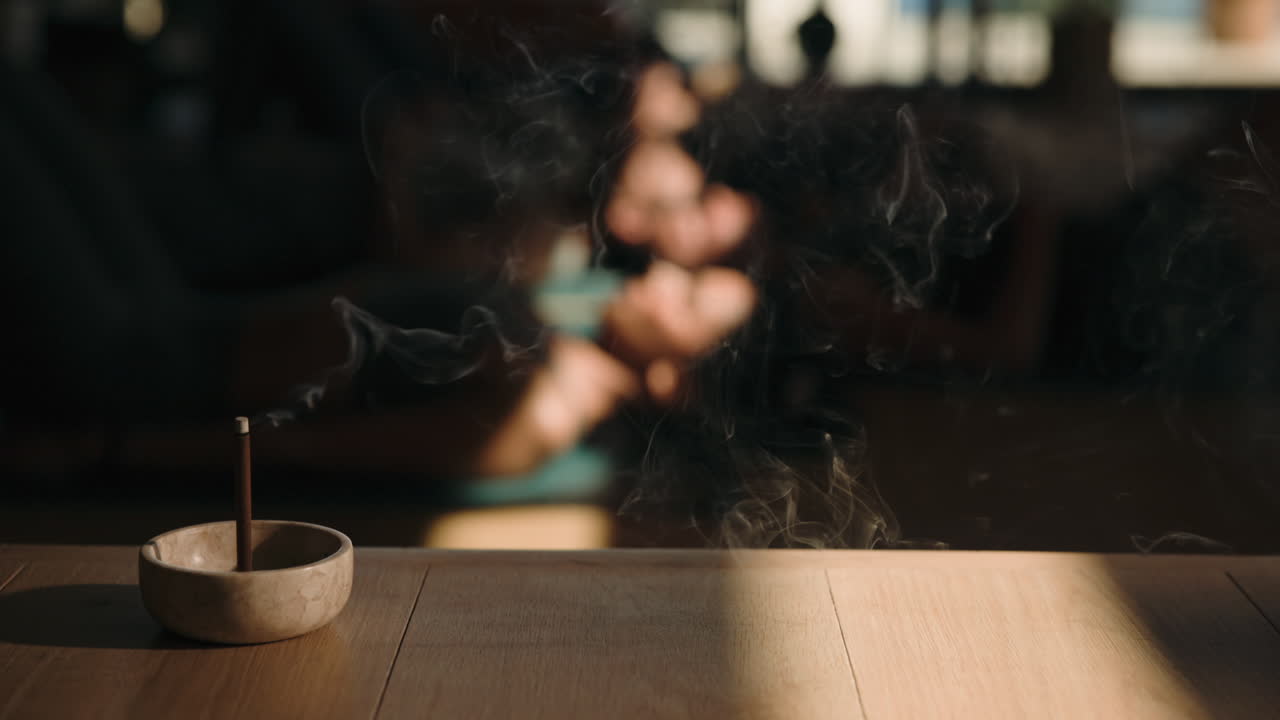Incense stick burning on a wooden table