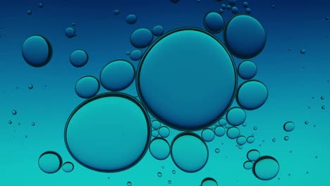 blue purple oil droplets abstract background. organic texture of oil bubbles in water seamless loop.