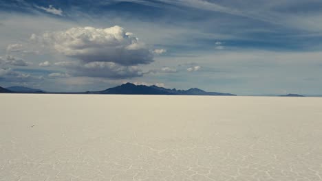 Aerial-view-close-to-the-ground-of-the-Bonneville-salt-flats-and-mountain-landscape-on-a-sunny-day