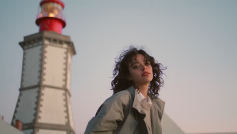 beautiful girl resting lighthouse view. vertical young woman look camera walk