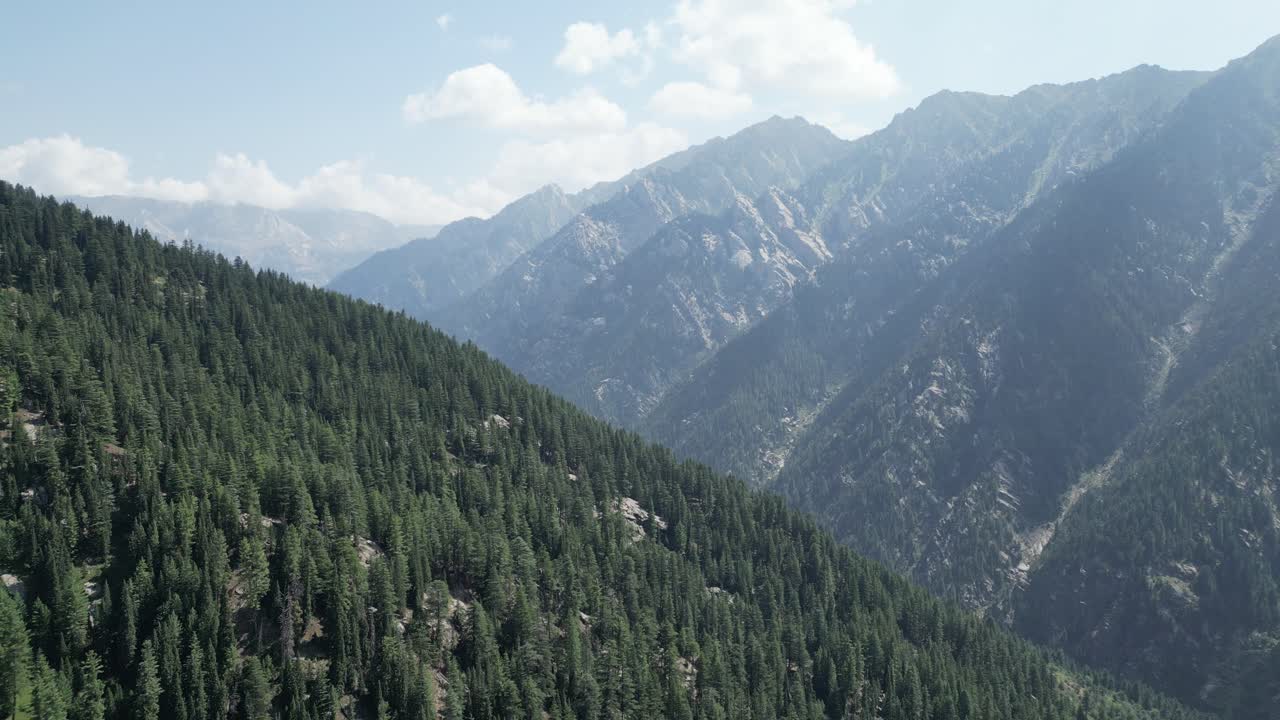 Silk road Aerial drone, Afghanistan River valley , green mountains and forest in Nuristan National Park