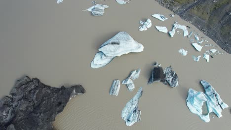 aerial view of icebergs floating in a glacier lake in iceland during summer