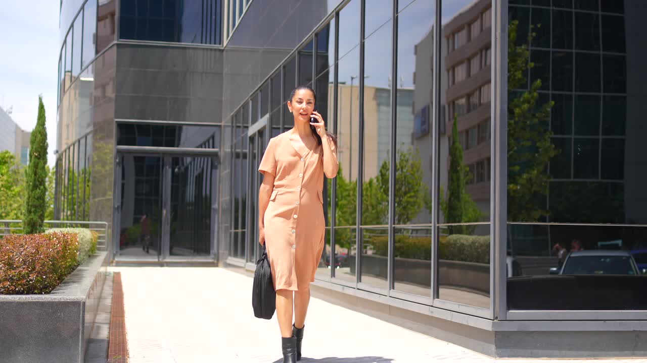 Businesswoman on the phone outside an office building
