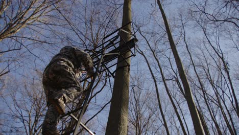 Hunter-Climbs-Down-Tree-Stand-During-Hunting-Season