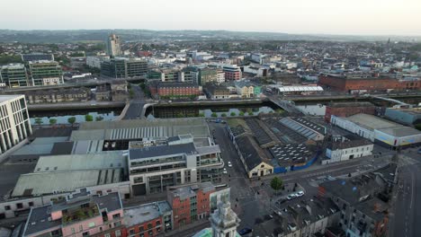 right panning establishing aerial shot of cork city reveals golden sunset, 4k