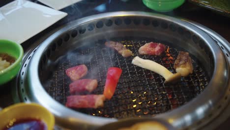 flames on grill as japanese wagyu is placed, close shot